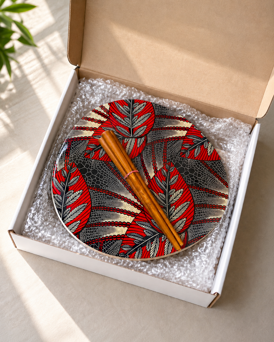 Red leaves large resin table packed for shipping. Available at Mopti Living.