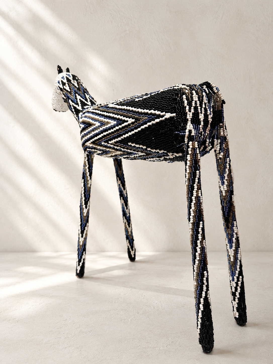 Hand-shaped beaded giraffe sculpture with black, white and blue beadwork pattern — Mopti Living