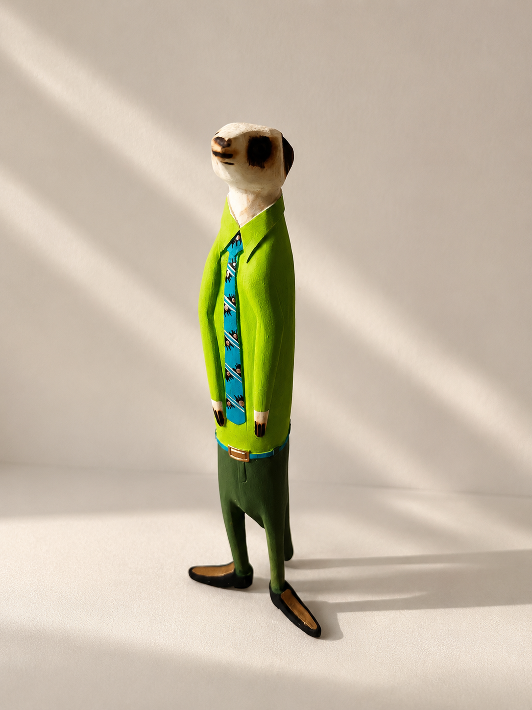 Hand-painted wooden meerkat figurine in green suit — Mopti Living