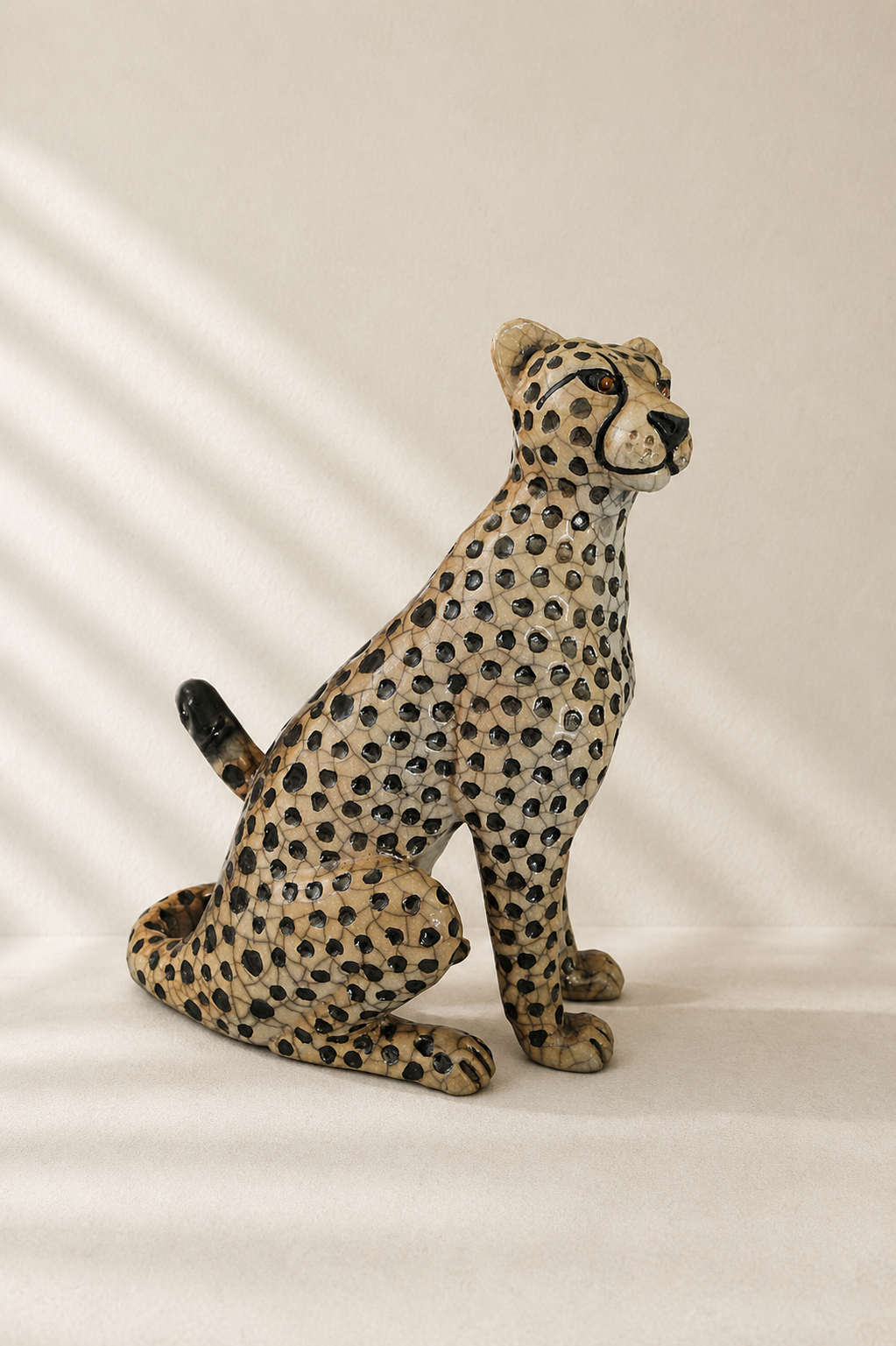Handmade Raku pit-fired ceramic cheetah sculpture, crackled surface, seated pose — Mopti Living