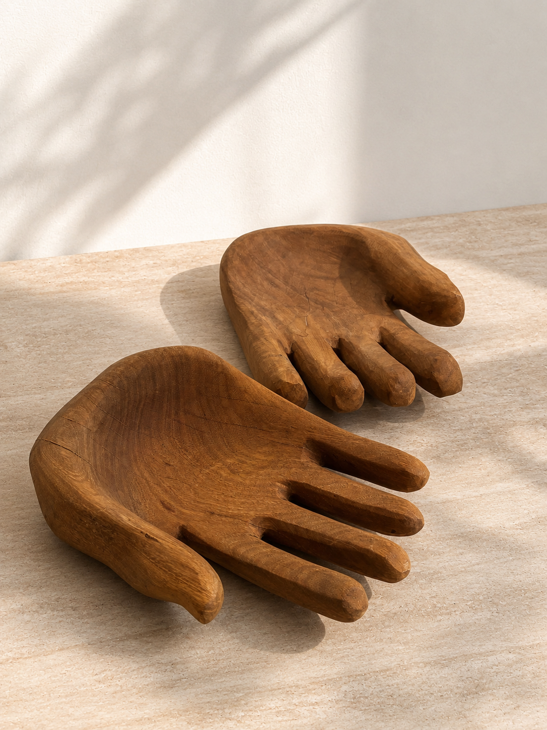 Hand-carved wooden open hand sculpture with palm facing upward, showing natural wood grain and tool marks — Mopti Living
