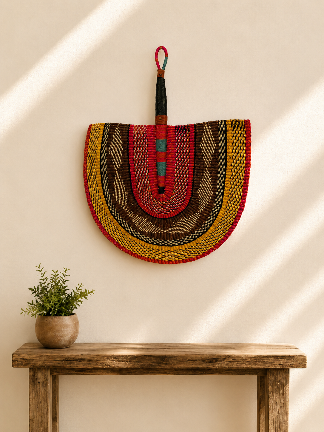 Handwoven Bolga wall fan in yellow and red — Naba Penga Fan by Mopti Living