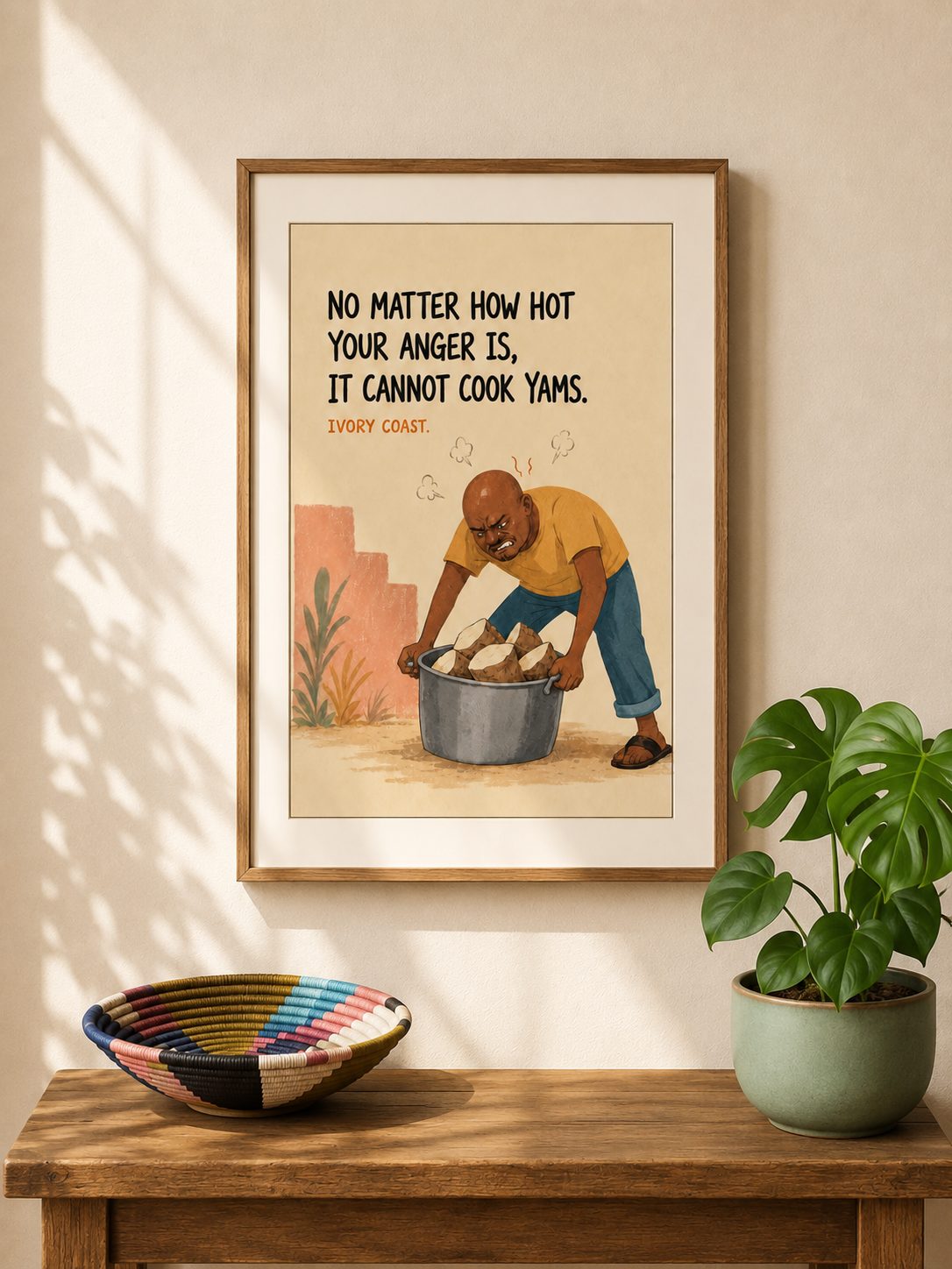 Framed illustrated art print from Ivory Coast — an angry man in a yellow shirt scowls as he shoves raw yams into a cold pot. Proverb: No matter how hot your anger is, it cannot cook yams. From Mopti's African Proverbs Series.