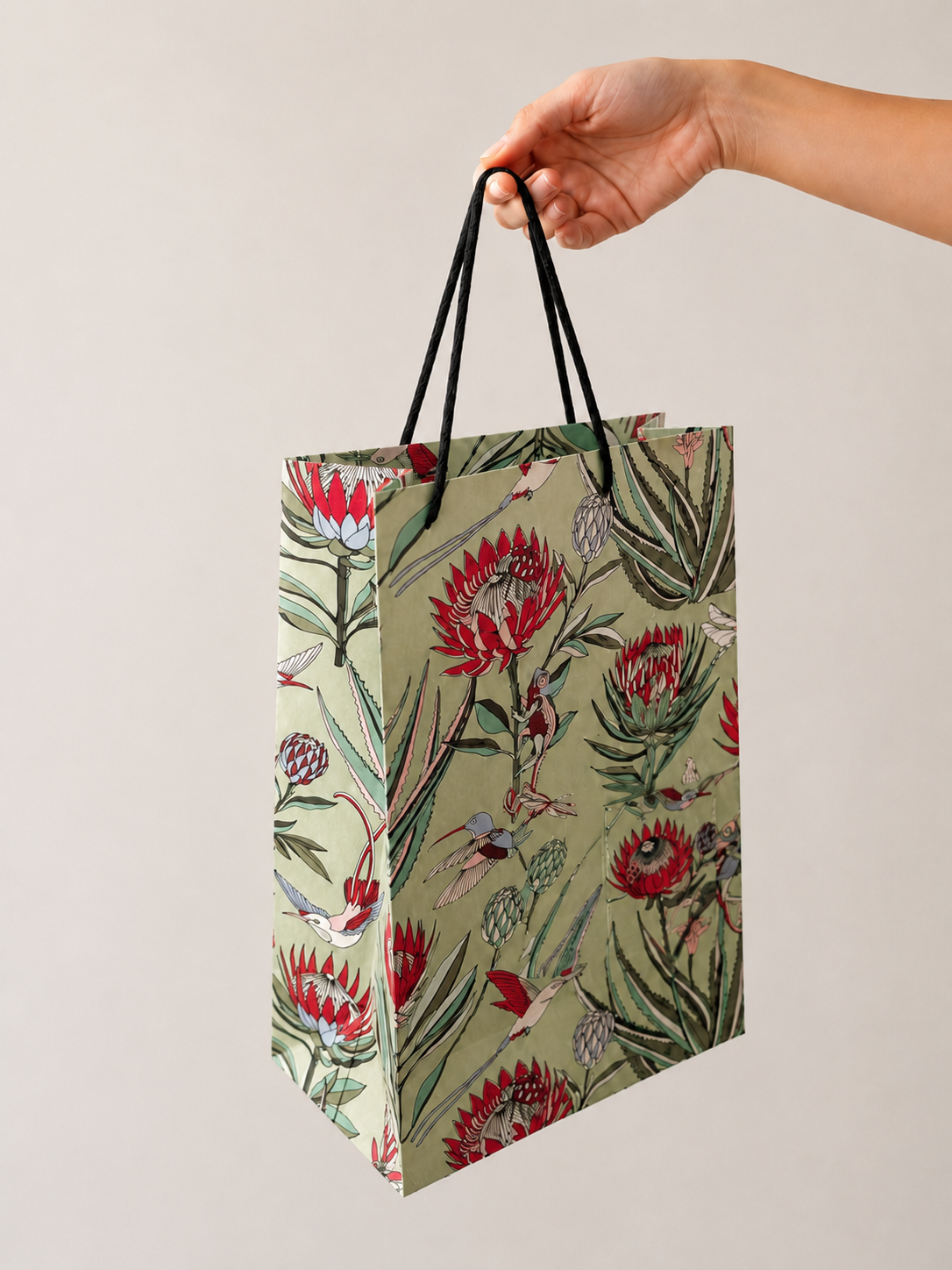 Designer gift bag in Avo green – botanical illustrated pattern with rope handles by Mopti Living