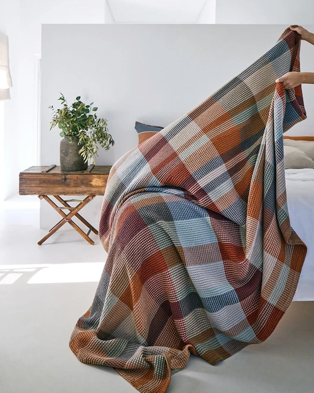 Vrou Vrou waffle cotton blanket in Cedarwood warm tones, draped — Mopti Living