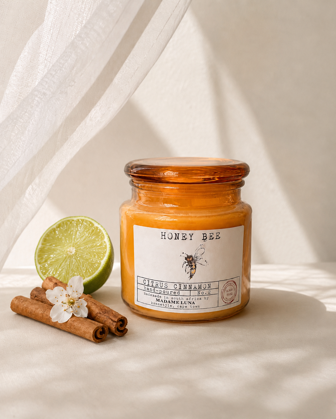 Citrus cinnamon soy candle in an amber glass jar by Mopti Living