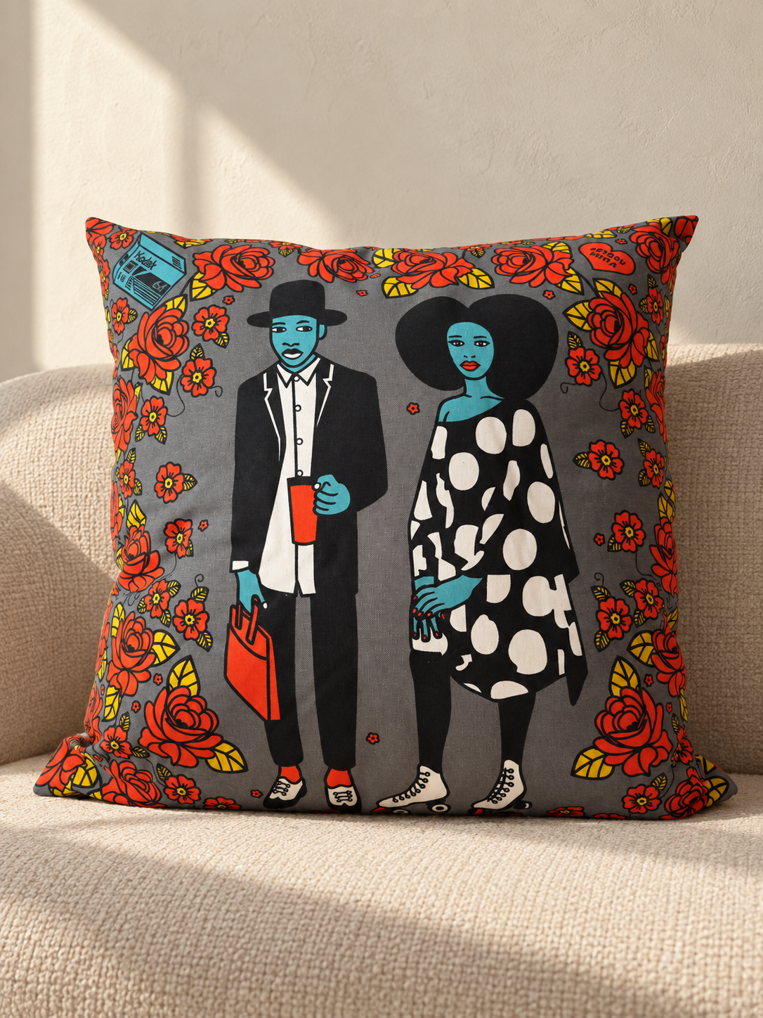 Mickey & Mercy: Grey Shine Shine cushion with an illustrated couple, red roses and yellow leaves.
