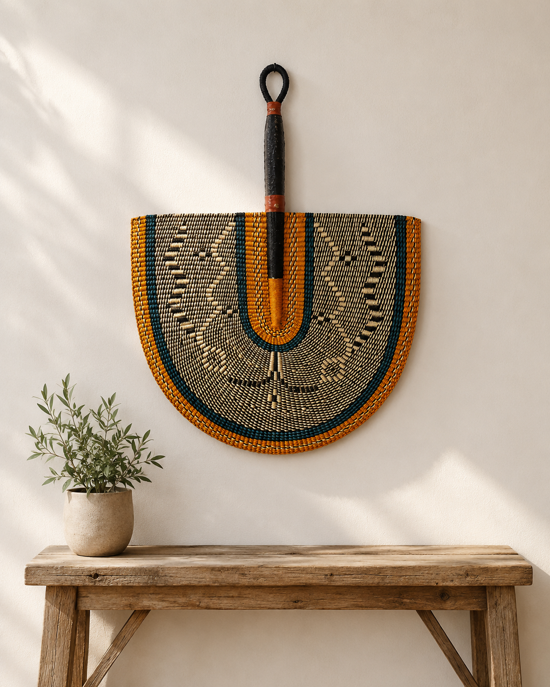 Handwoven Bolga wall fan in orange and green — Naba Penga Fan by Mopti Living