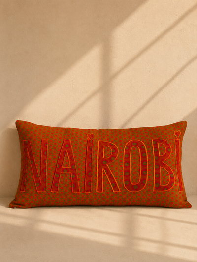 Nairobi shweshwe cushion cover in orange on green – hand-appliquéd lettering, handmade in Kenya | Mopti Living