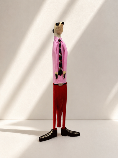 Hand-painted wooden meerkat figurine in pink and red suit — Mopti Living