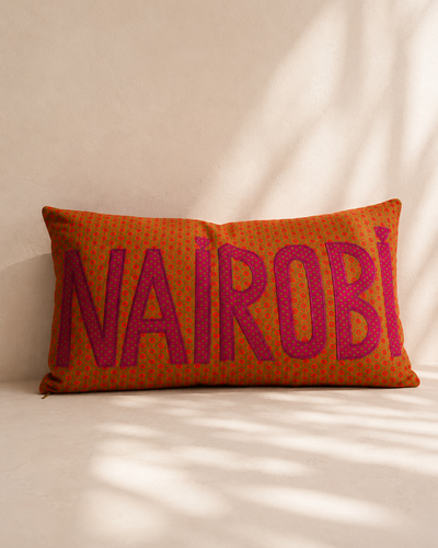 Nairobi shweshwe cushion cover in pink on green – hand-appliquéd lettering, handmade in Kenya | Mopti Living