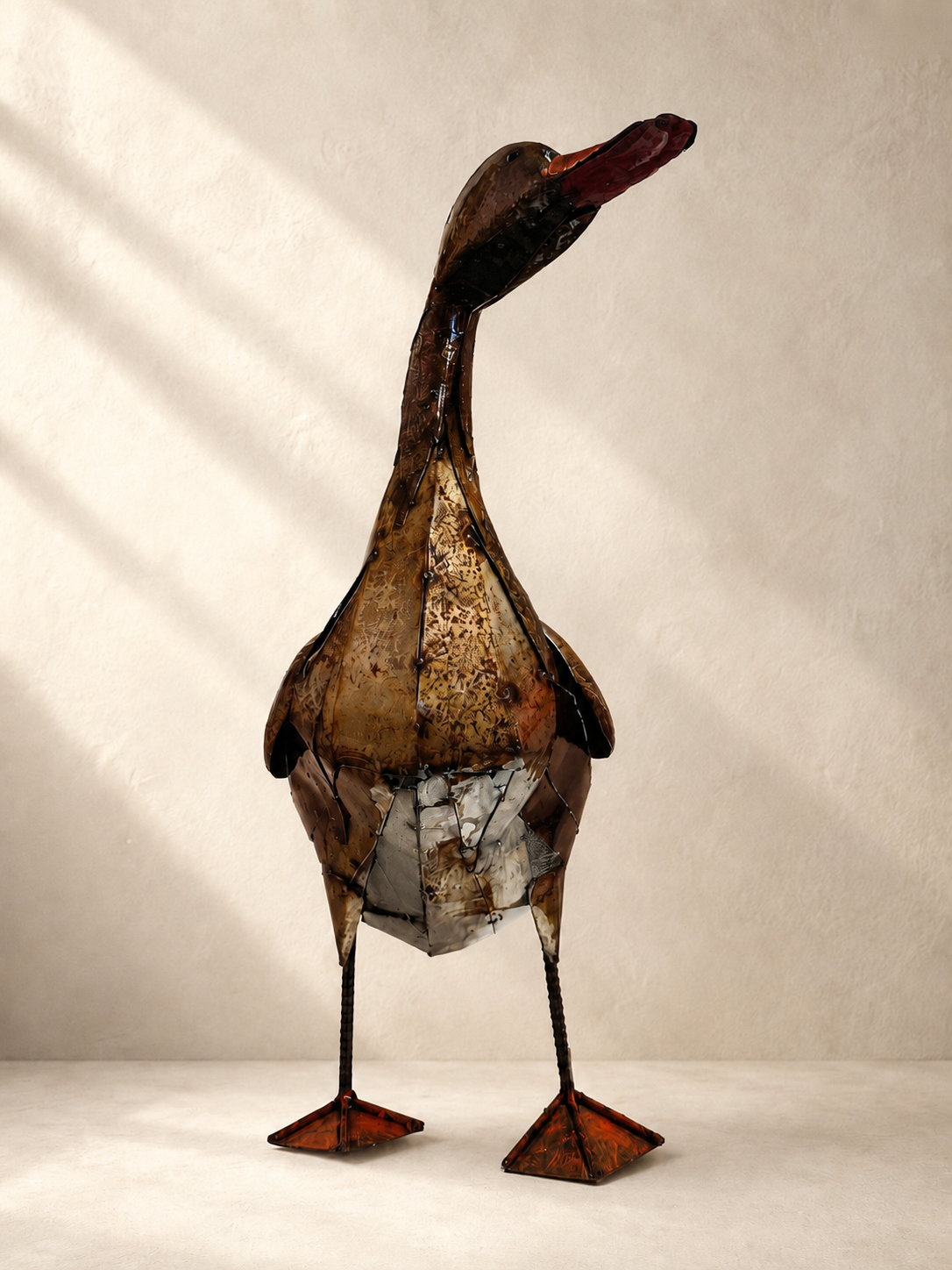 Handmade recycled metal duck sculpture with layered patina and textured finish — Mopti Living

