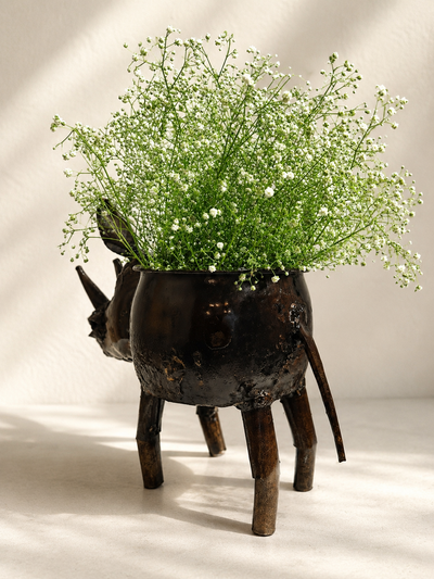 Handmade recycled metal rhino planter with dark finish and visible joins — Mopti Living