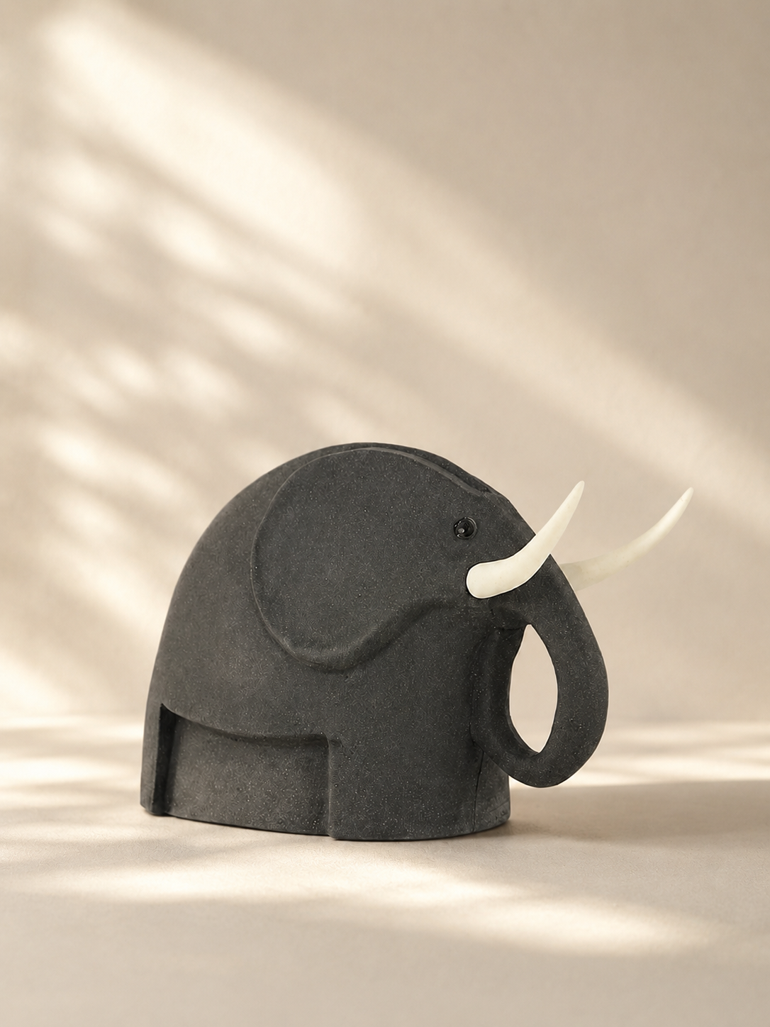 Handmade charcoal stoneware elephant sculpture with white tusks, small — Mopti Living